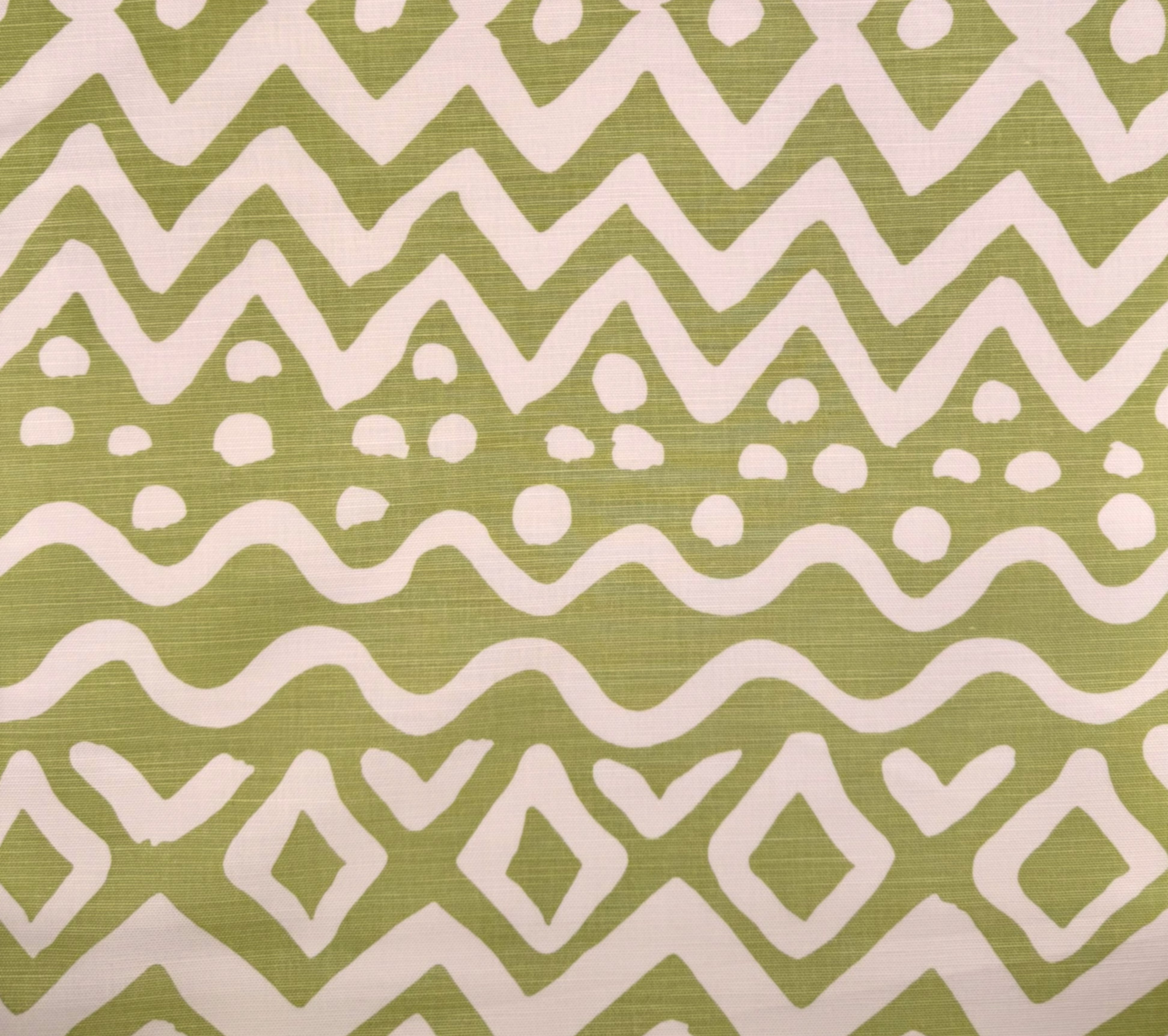 Patterned fabric with white zigzag and diamond shapes on a green background