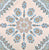 Decorative pattern with blue and brown elements on a beige background