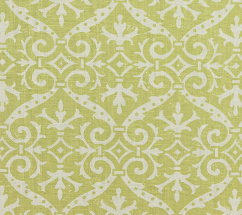 A close-up view of a fabric featuring a traditional damask print with floral and leaf motifs in a custom French green color on a tinted background.