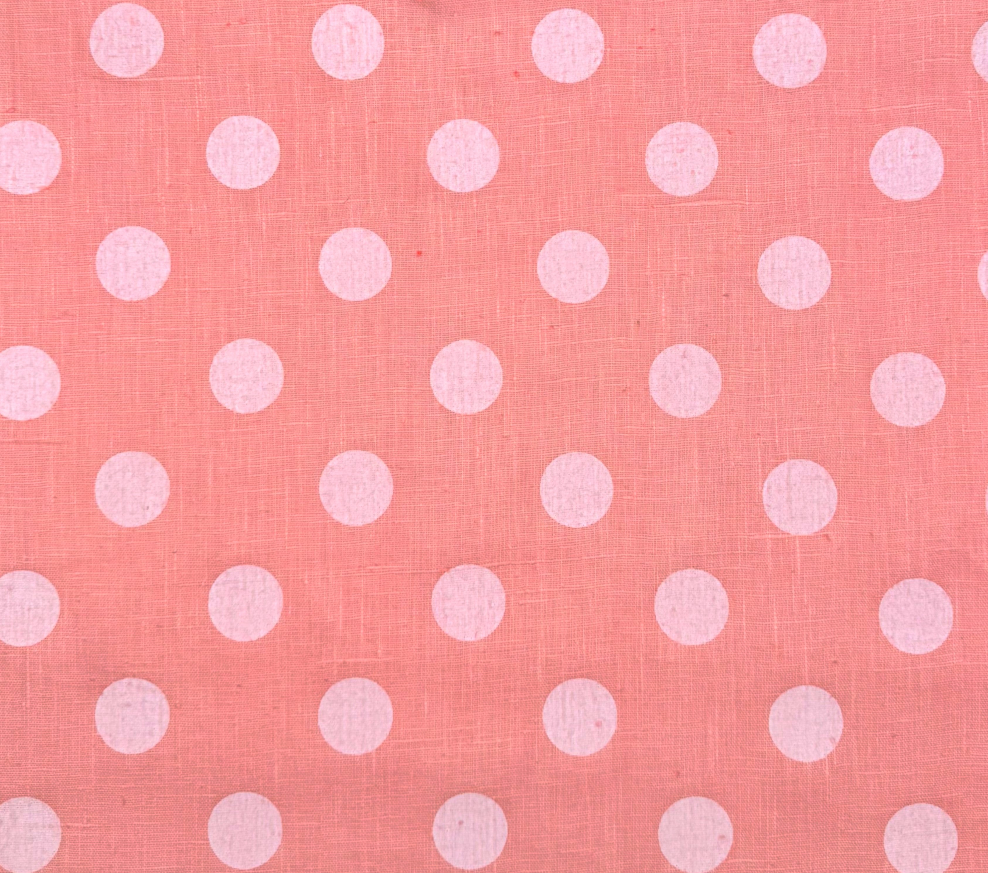 Pink fabric with white polka dots