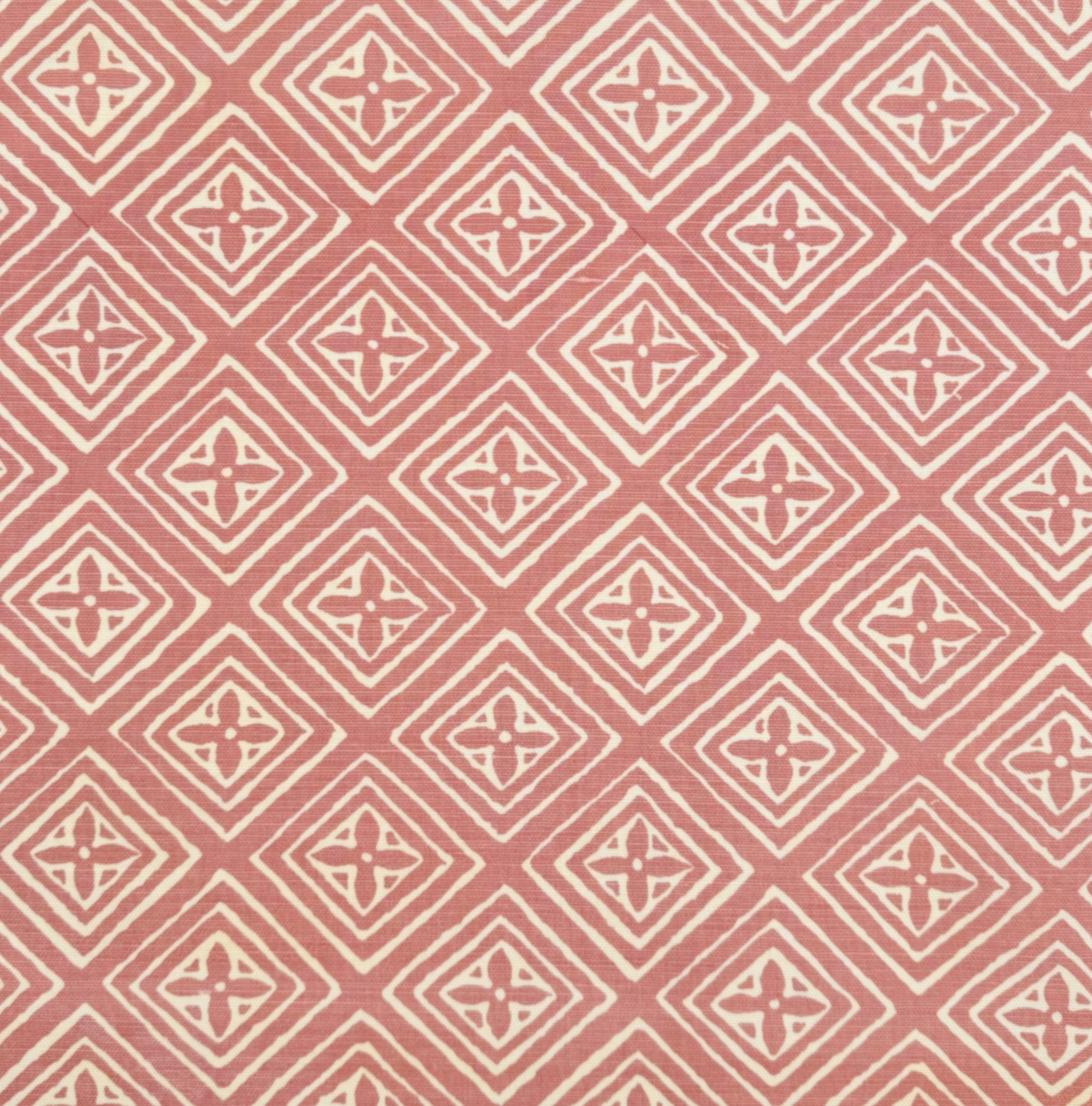 Patterned fabric with geometric design on a pink background