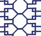 A close-up of a section of Quadrille Brighton fabric featuring a geometric pattern of navy and white suncloth.