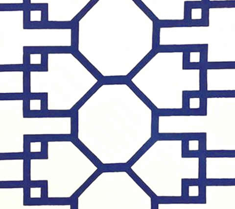 A close-up of a section of Quadrille Brighton fabric featuring a geometric pattern of navy and white suncloth.