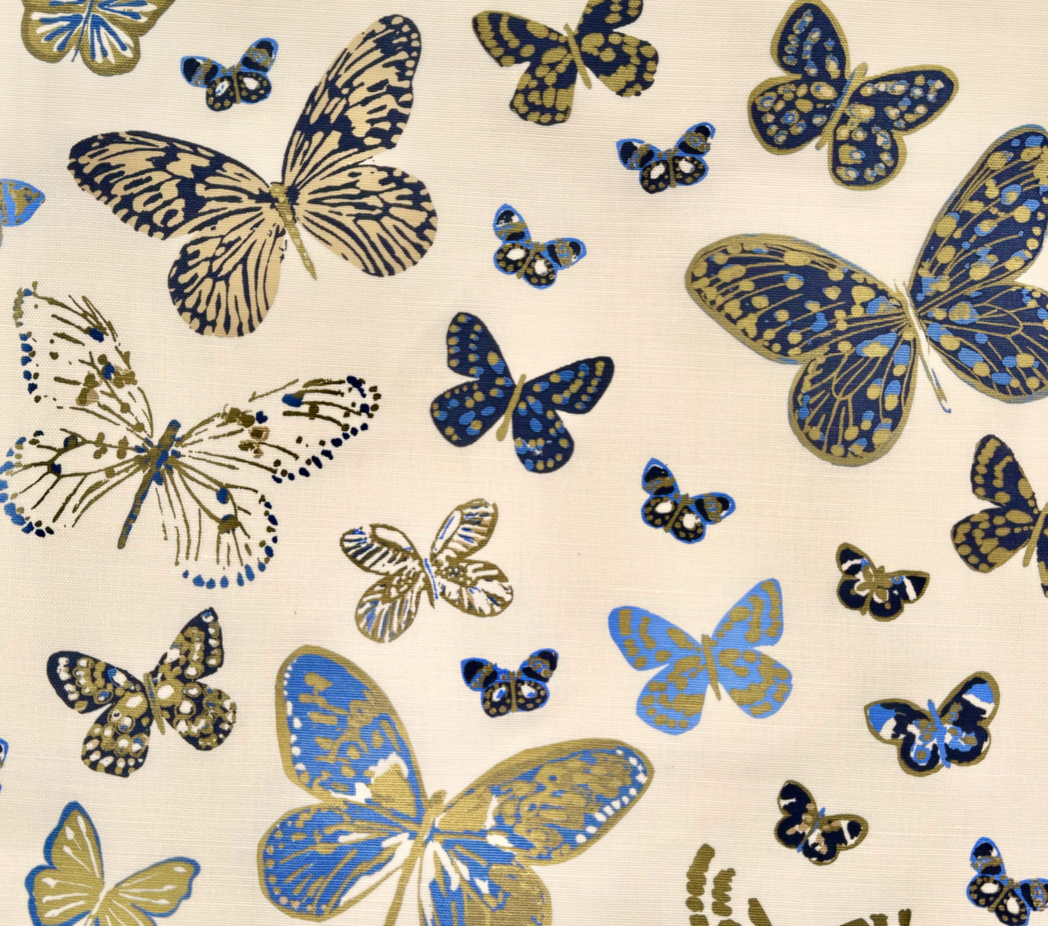 Pattern of blue and gold butterflies on a beige background